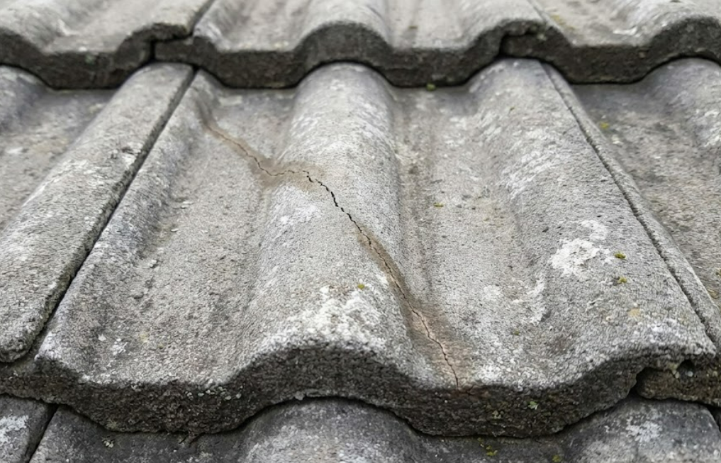Close up of a cracked roof tile showing structural damage